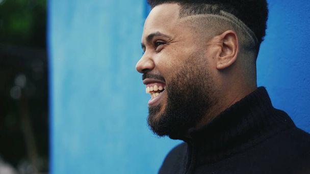 A happy hispanic black man laughing and smiling outside - Zdjęcie, obraz