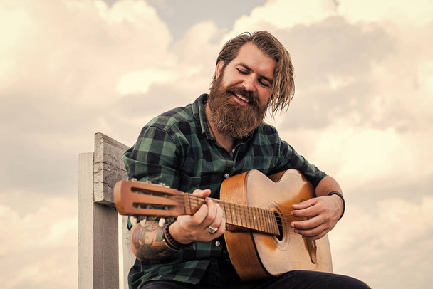 mature bearded man looking casual trendy playing guitar, guitarist - Photo, Image