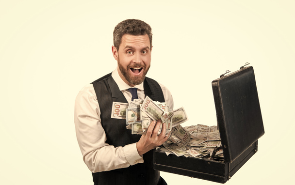 surprised millionaire holding case full of dollar cash isolated on white background, investment - Photo, Image