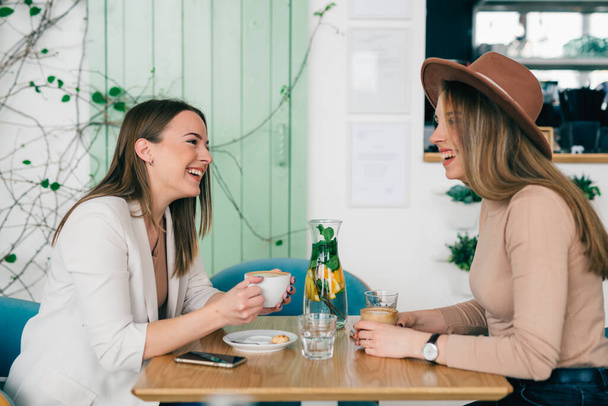 women enjoying time together on a coffee break in cafeteria - Фото, зображення