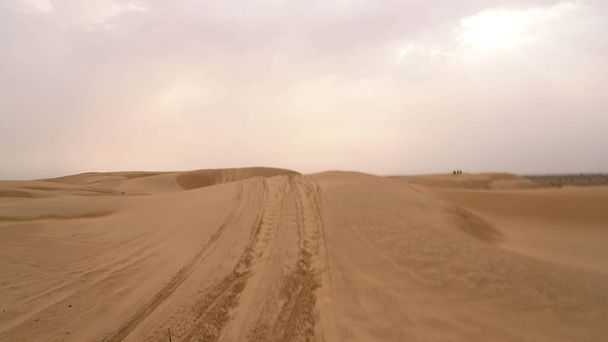Dunas de areia natural com marcas de pneus de carro durante o dia - Foto, Imagem