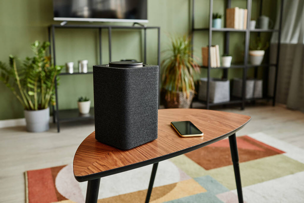 Background image of smart speaker with home AI system on wooden table in modern interior, copy space - Zdjęcie, obraz