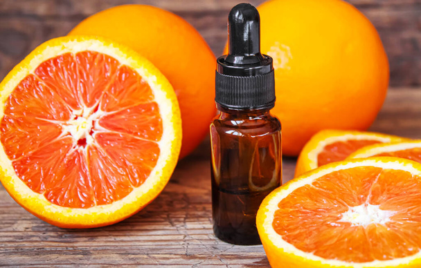 Grapefruit essential oil in a small bottle. Selective focus. Food. - Photo, Image
