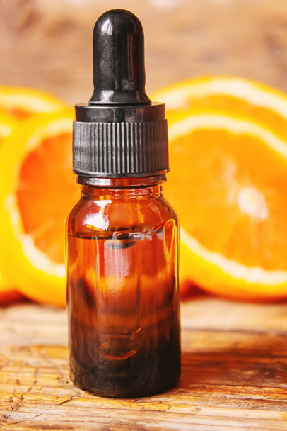 Grapefruit essential oil in a small bottle. Selective focus. Food. - 写真・画像