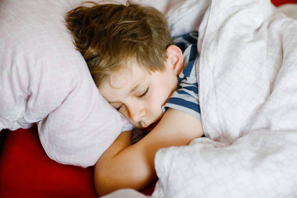 Preteen kid boy sleeping in bed. School child dreaming. Tired teenager sleep. - Φωτογραφία, εικόνα