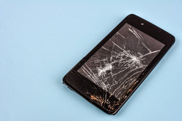 Mobile smartphone with broken screen isolated on white.Damaged mobile phone, cracked modern touch screen.Electronics repair service, accident insurance concept. - Foto, Imagen