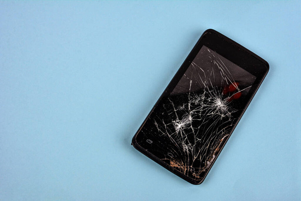 Mobile smartphone with broken screen isolated on white.Damaged mobile phone, cracked modern touch screen.Electronics repair service, accident insurance concept. - Фото, зображення