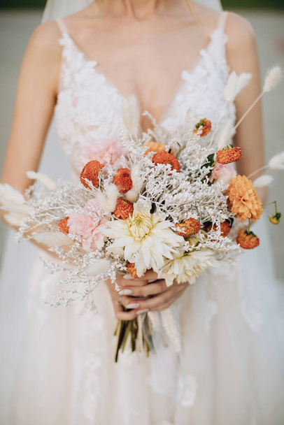 The bride holds a beautiful bouquet in the style of boho - Valokuva, kuva