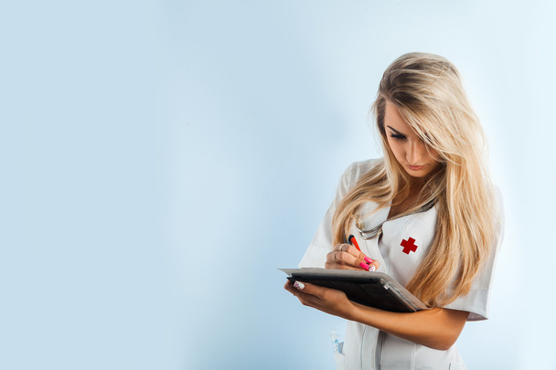 horizontal photo of charming nurse with stethoscope and tablet - Foto, imagen