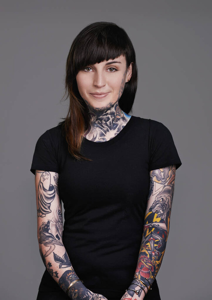 Let your beauty rise to the surface. A cropped studio portrait of a beautiful tattooed young woman. - Foto, Bild