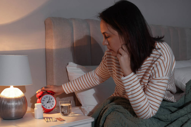 Mature woman suffering from insomnia in bedroom at night - Fotoğraf, Görsel