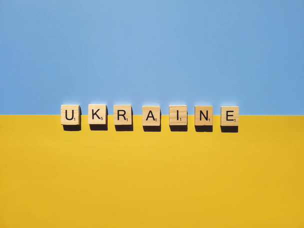 Words on wooden alphabet letters on yellow, blue background close up. Flat lay. Concept of Ukraine freedom and support. Protest action. Stop war. - Φωτογραφία, εικόνα