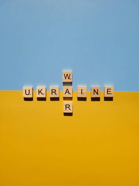 Words on wooden alphabet letters on yellow, blue background close up. Flat lay. Concept of Ukraine freedom and support. Protest action. Stop war. - Φωτογραφία, εικόνα