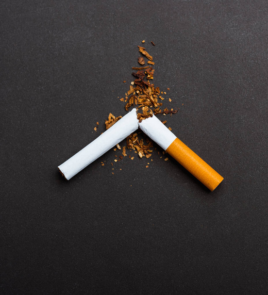 31 May of World No Tobacco Day, no smoking, close up of broken pile cigarette or tobacco STOP symbolic on black background with copy space, and Warning lung health concept - Foto, Bild