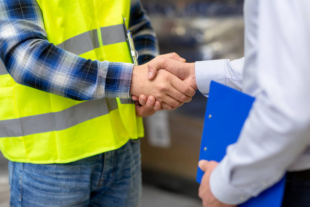 worker and businessman shaking hands at warehouse - Fotoğraf, Görsel