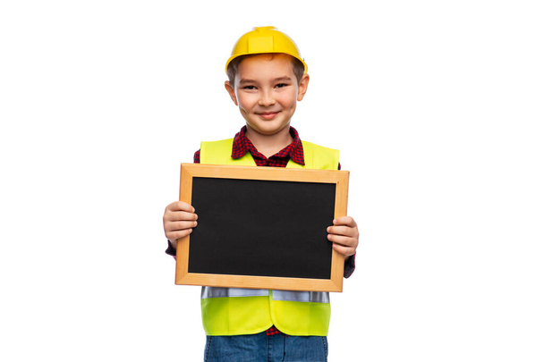 little boy in protective helmet holding chalkboard - Fotó, kép