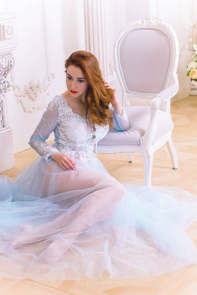 Concept of tenderness and pure beauty in sweet princess look. Beautiful girl in a delicate lilac purple tulle dress at romantic interior, fairytale in modern life - Valokuva, kuva