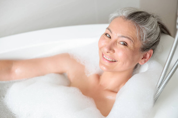 Happy woman resting in the spa after work - Photo, Image