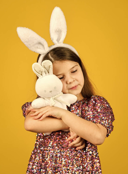 Tender love. Springtime concept. Little girl hold hare toy. Happy childhood. Cute child play with toy. Toys shop. Girl in adorable funny rabbit ears. Happy easter holiday. Spring holiday preparation - Fotografie, Obrázek