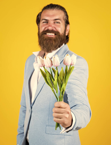 Take it. happy fathers day. mature bride groom with bouquet. hipster man hold tulip flowers. gift for romantic date. bearded man in elegant jacket hold flowers. wedding day - Fotografie, Obrázek