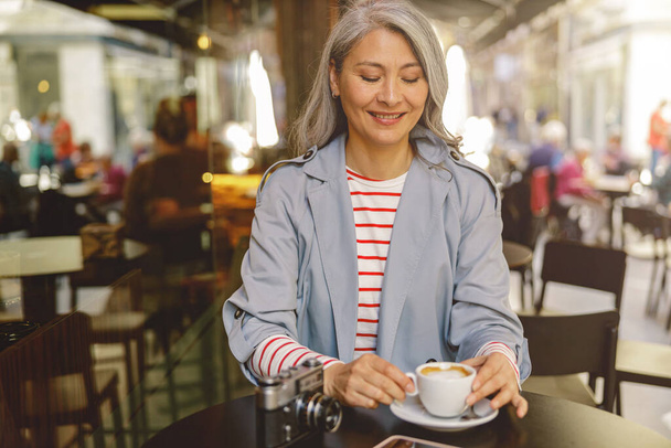 mujer asiática con taza de café en café - Foto, imagen