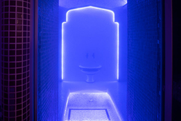 Turkish bath hammam, a lot of steam in the Turkish sauna. Illuminated with blue light - Фото, изображение