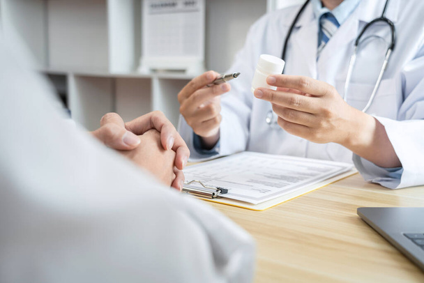 Doctor discussing with the patient using the medicine something and recommend treatment methods, Presenting results on report, Medicine and Healthcare concept. - Foto, imagen