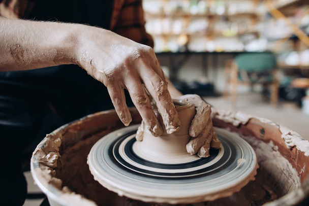 Potter's hands working clay on a potter's wheel. Master Class - Zdjęcie, obraz