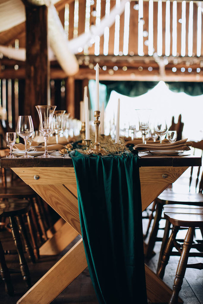 Elegant wooden wedding table for dinner in rustic style with candles - 写真・画像