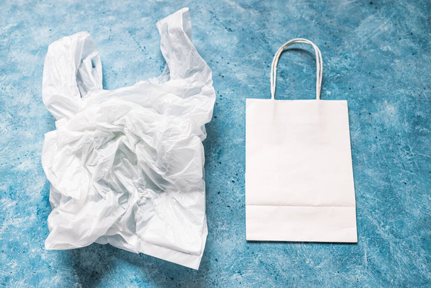 single use plastic bag next to paper one, plastic pollution and environmental awareness concept - Fotoğraf, Görsel