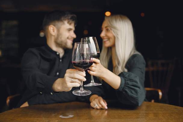 Romantic couple drinking wine at restaurant - Fotó, kép