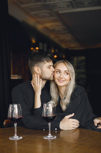 Couple hugging and have wine in cafe - Zdjęcie, obraz