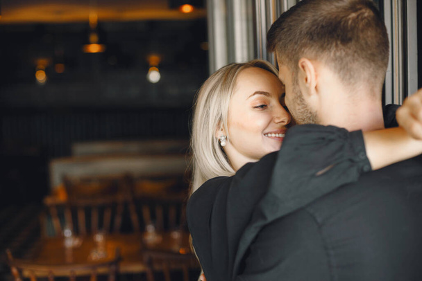 Romantic young couple hugging at cafe window - Valokuva, kuva