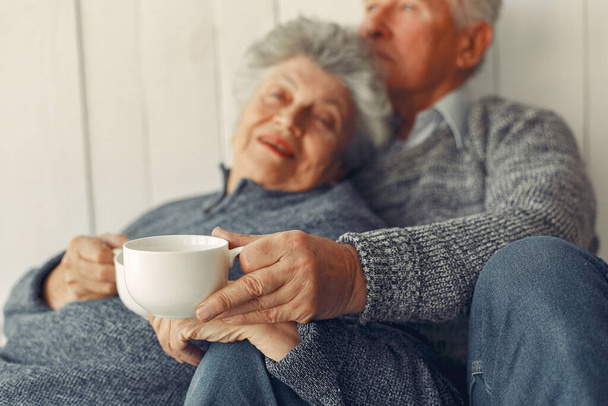 Elegant old couple sitting at home on a foor - Photo, Image