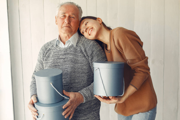 Elegant old man standing at home with his granddaughter - Fotoğraf, Görsel
