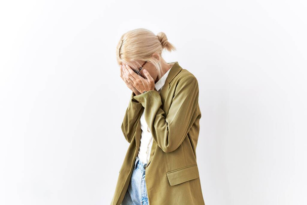 Beautiful caucasian business woman standing over isolated background with sad expression covering face with hands while crying. depression concept.  - Photo, Image
