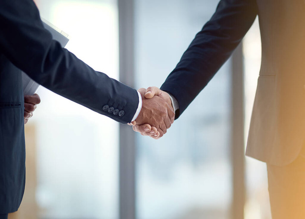 Lets seal the deal. Cropped shot of two businessmen shaking hands. - Фото, зображення