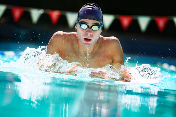 Taking a deep breath.... Cropped view of a male swimmer in mid lap. - Foto, immagini