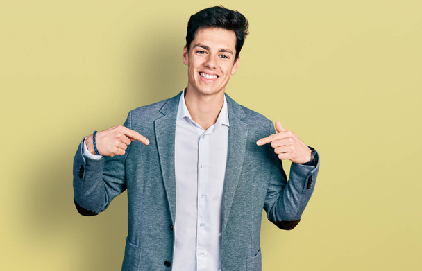 Young hispanic man wearing business clothes looking confident with smile on face, pointing oneself with fingers proud and happy.  - Photo, Image