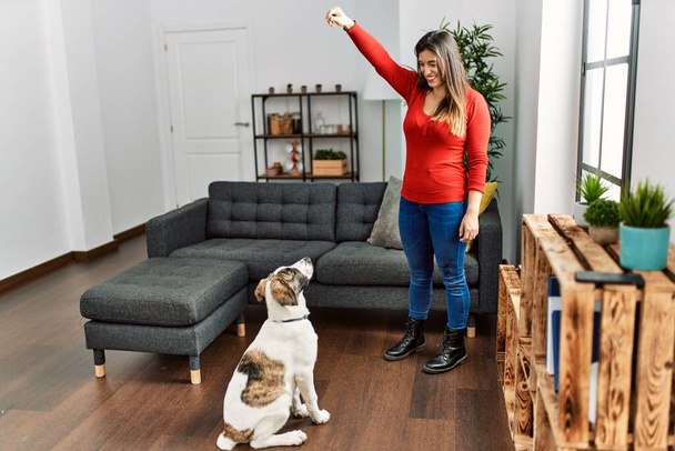 Young woman smiling confident teaching dog at home - Photo, Image