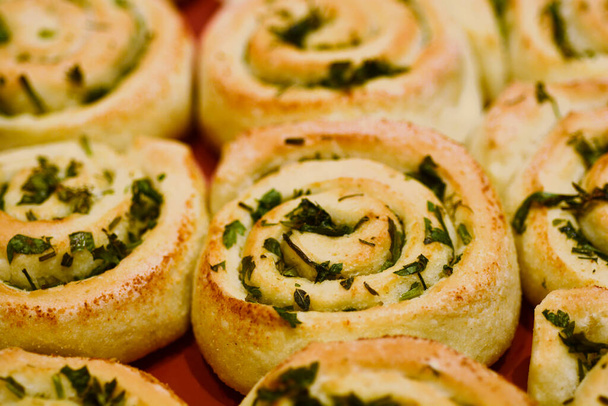 Close up of a tray with baked herb swirl buns - Fotó, kép