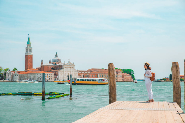 Turist kadın San Giorgio Maggiore Venedik 'e bakıyor. - Fotoğraf, Görsel