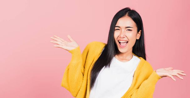 Happy Asian portrait beautiful cute young woman standing winning and surprised excited screaming open mouth raise hands, studio shot isolated pink background, Thai female wow with copy space - Фото, изображение
