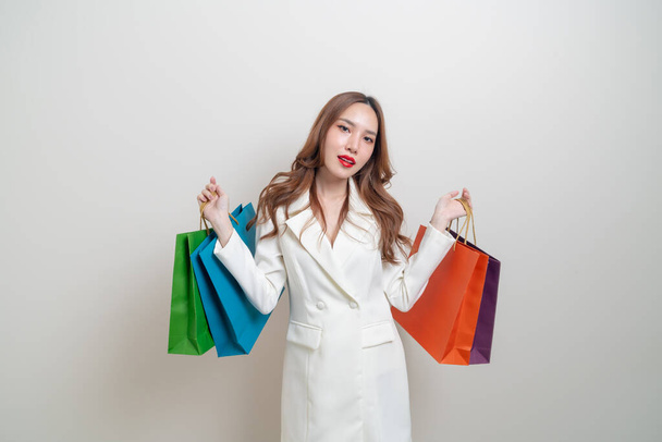 portrait beautiful Asian woman holding shopping bag on white background - Photo, Image