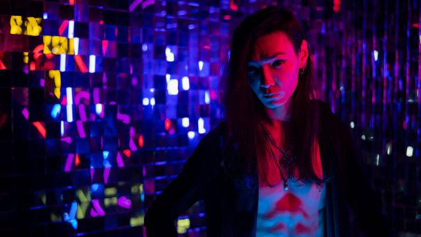 Portrait of a transgender model with a naked torso in a studio with neon lighting. - Fotoğraf, Görsel