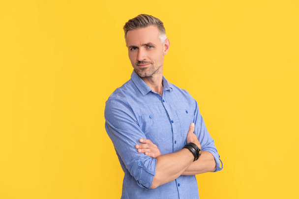 hair and beard care. male fashion model on yellow background. handsome guy with graying bristle. - Photo, Image