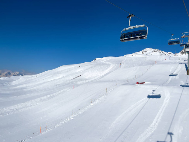 a ride in the chairlift over white slopes in the deserted ski area - Φωτογραφία, εικόνα