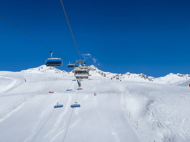 a ride in the chairlift over white slopes in the deserted ski area - Fotoğraf, Görsel
