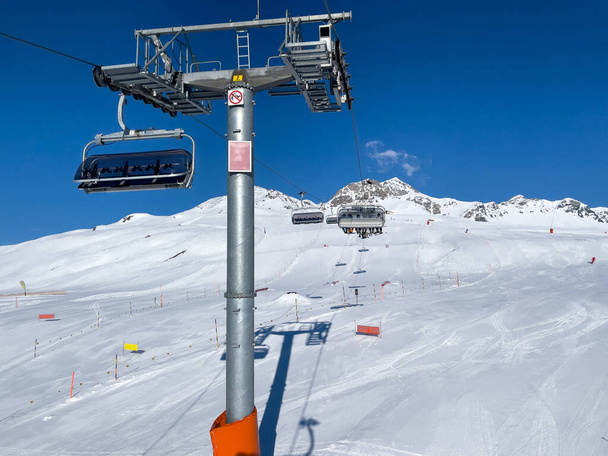 a ride in the chairlift over white slopes in the deserted ski area - 写真・画像