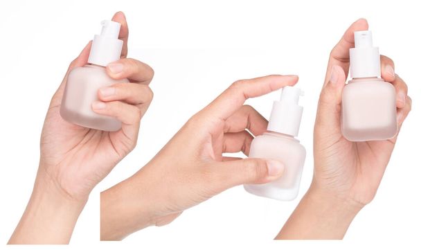 Collection of Hand holding Foundation butelka kosmetyczna izolowana na białym tle. - Zdjęcie, obraz